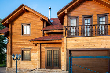 Modern wooden timber eco house villa facade during process of renovation, sanding wall for varnishing against sun burn, bark beetle moisture at countryside villa. Home exterior repair and maintenance