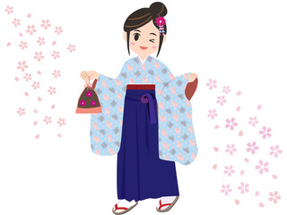 桜舞い散る中、袴姿で卒業式へむかう女性
