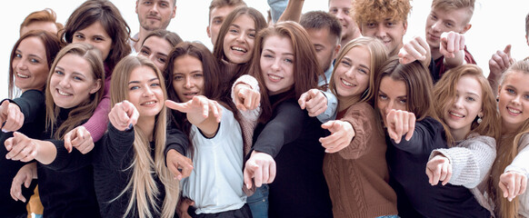 large group of casual young people pointing ahead