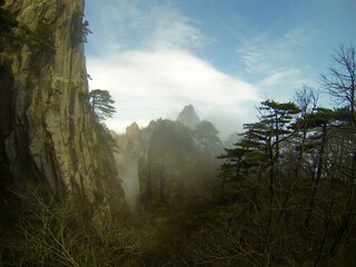 China Mount HuangShan - April, 2015: Natural scenery, sunsets, peculiarly-shaped granite peaks, Huangshan pine trees and views of the clouds from above. Photo taken in Yellow Mountain (UNESCO).
