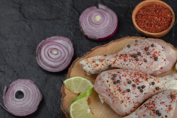 Close up spicy Raw chicken legs with vegetable on Wooden board