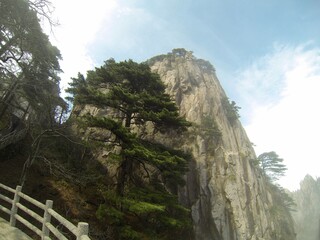 China Mount HuangShan - April, 2015: Natural scenery, sunsets, peculiarly-shaped granite peaks, Huangshan pine trees and views of the clouds from above. Photo taken in Yellow Mountain (UNESCO).