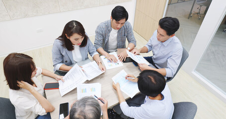 Coworkers discuss at table © ryanking999