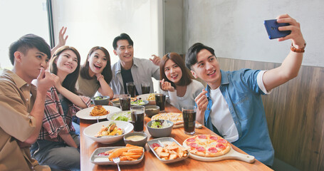 friends take selfie in restaurant