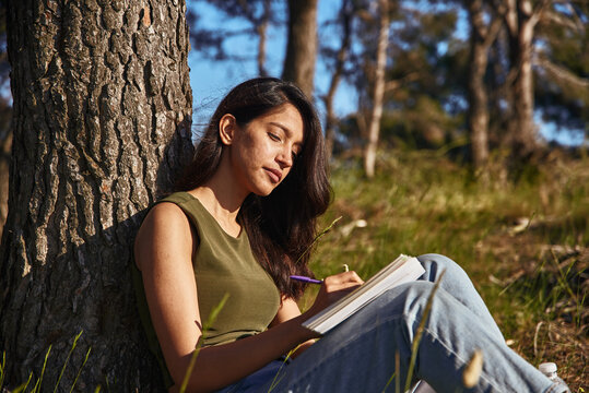 Busy Young Lady Writing In Her Journal Outside