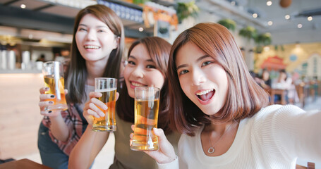 friends toast beer in restaurant