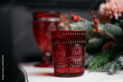 table setting for a festive event or family dinner: decoration with ecological, natural decor-spruce, cotton, rose. Holiday card for Mother's Day or Women's Day. Use of wax candles and clear mugs.