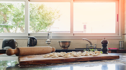 Kitchen illuminated by a beautiful light coming through the window, where there is homemade food. Homey concept.