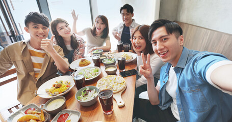friends take selfie in restaurant