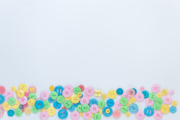 Colorful buttons on a white background. A place for text. Green, blue, yellow, pink buttons.