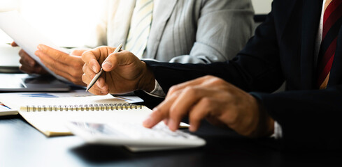 Asian male finance or accountant financier working audit and calculating expense financial annual...