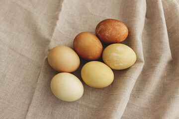 Modern brown and yellow easter eggs on rustic linen cloth, ombre tones. Happy Easter! Aesthetic