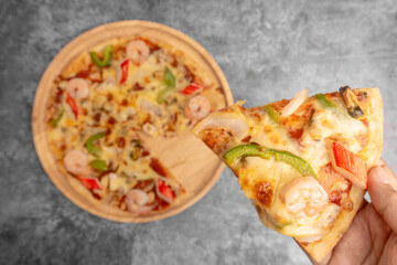 Selective ficused pizza topped seafood on hand.