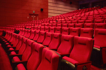 Red chairs in an empty concert hall