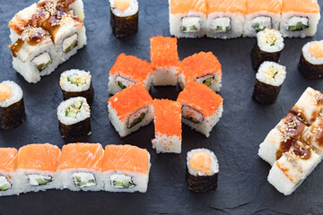 Assorted from the roll. Japanese cuisine. rolls on a stone platter. serving the table.