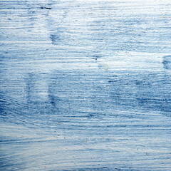 Blue grey wooden background with white stains of acrylic paint