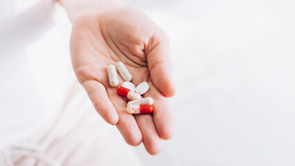 Medical pills tablets lie in woman's hand. Health and medicine. Selective focus