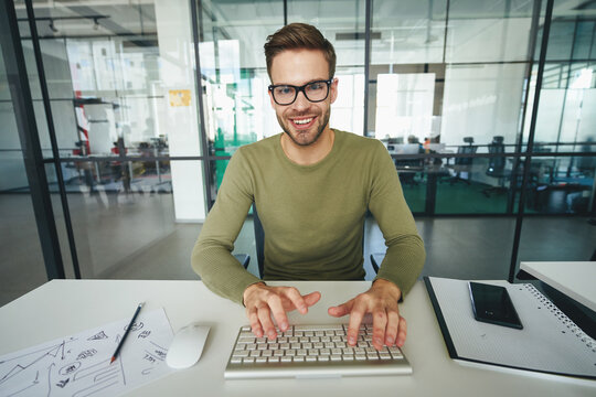 Enthuasiastic gentleman using keyboard and posing for camera