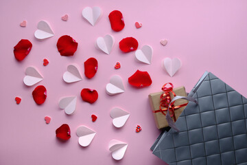 Grey paper bag, red and pink hearts and gift on white background. Valentine day concept.