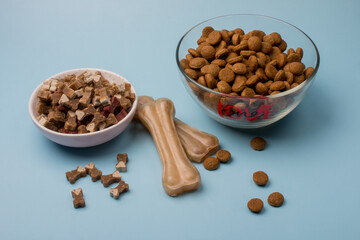 dog food in a bowl and a bone for brushing your teeth. Animal feeding
