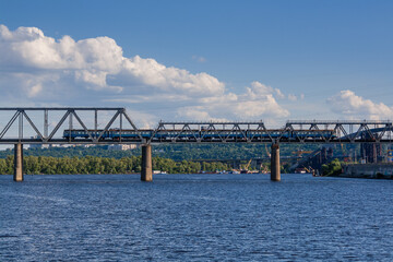 Railway bridge across the river on which the train is traveling