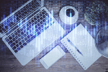 Financial market graph and top view computer on the desktop background. Double exposure. Investment concept.