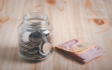 Coins Stack and bills in the glass jar. Concept of money saving, financial. Savings money and income Investment ideas and financial management for the future.
