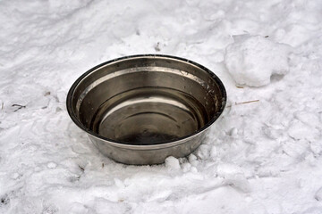 iron bowl with water to drink to animals in the snow