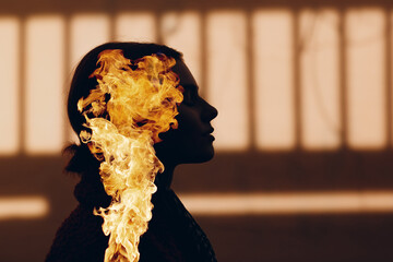 Double exposure portrait of woman with fire in her head