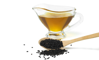 Wooden spoon with black cumin seeds and black seed oil Isolated on white background. Selective focus. .