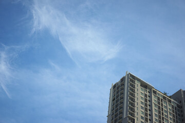 modern skyscraper against clouds and sky