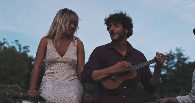 Two handsome musicians playing ukulele and singing