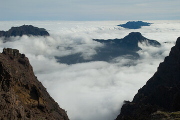 Volcanic crater covered by a sea of clouds. Caldera de Taburiente National Park and Cumbre Vieja in the background. La Palma. Canary Islands. Spain.