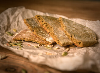 Made by hand fresh tortillas on parchment paper and ear of ripe wheat on the wooden table