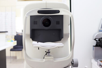Computer optometer located in the optics salon. Optical autorefractor. Vision examination by an optometrist. Selection of optical correction and correcting glasses for vision