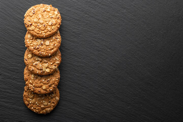 oatmeal cookies with grains on a stone background
