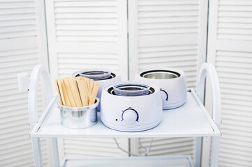 Preparing wax for shugaring. Depilatory wax close-up is heated and melted in a beauty salon