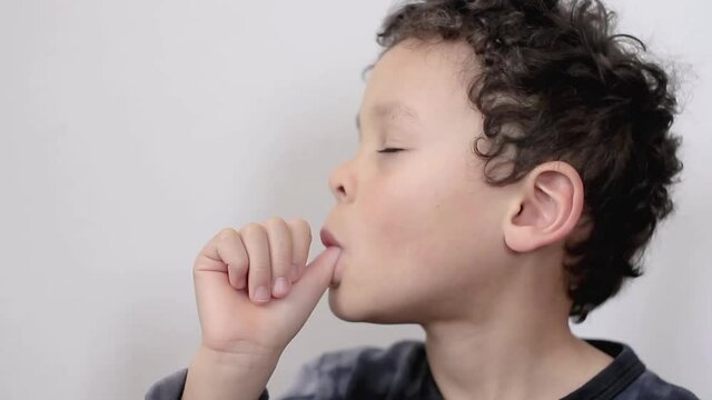little boy sucking thumb on white background stock footage
