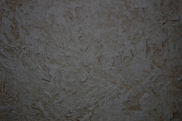 Designed stone structure with orange spots stucco background (plastered wall texture).	