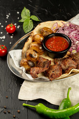 Kebap, roasted meat and vegetables on grill
