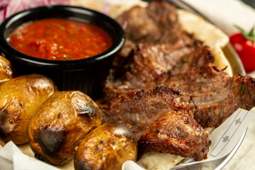 Kebap, roasted meat and vegetables on grill