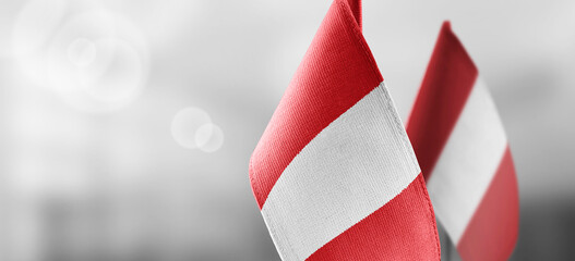 Small national flags of the Peru on a light blurry background - obrazy, fototapety, plakaty