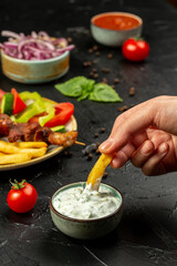 Kebap or shashlik and french fries and fresh vegetables