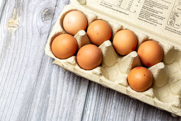 A Box of British eggs in an egg box on a wooden table
