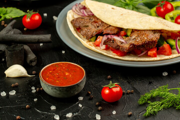 Kebap wrapped in a very thin pita or lavash 