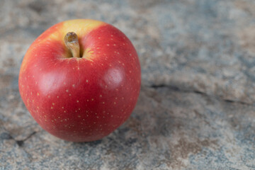 Red apples isolated on a grey marble background