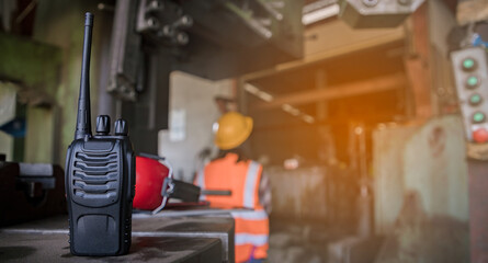 Close up, Walkie-Talkie of Engineer worker wearing safety goggles control lathe machine to drill components by wrench. Metal lathe industrial manufacturing factory indoors. Sander concept. © krumanop
