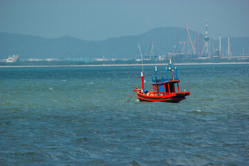 Fototapeta premium A red fishing boat in the sea