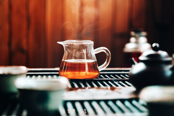 Teapot with fresh tea on wooden table , tea ceremony chinese style, sunlight
