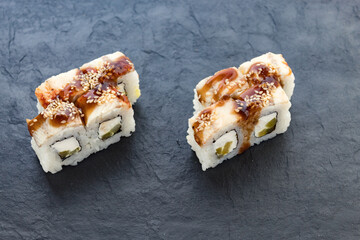 rolls with teriyaki sauce. Rolls and sushi. Avocado, rice, eel. Eel rolls. serving a dish